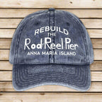 Blue denim cap with white text on a wooden surface