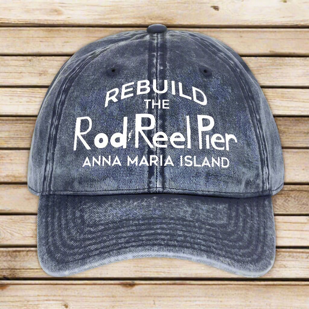 Blue denim cap with white text on a nautical wood background