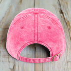 Pink denim cap on a wood deck