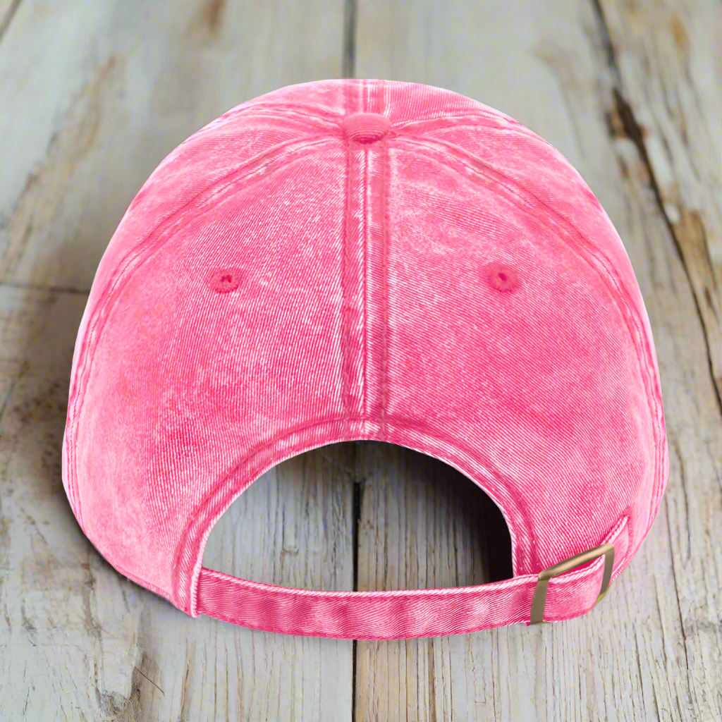 Pink denim cap on a wood deck
