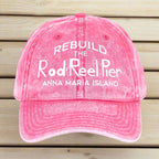 Pink cap with white text on a wooden surface