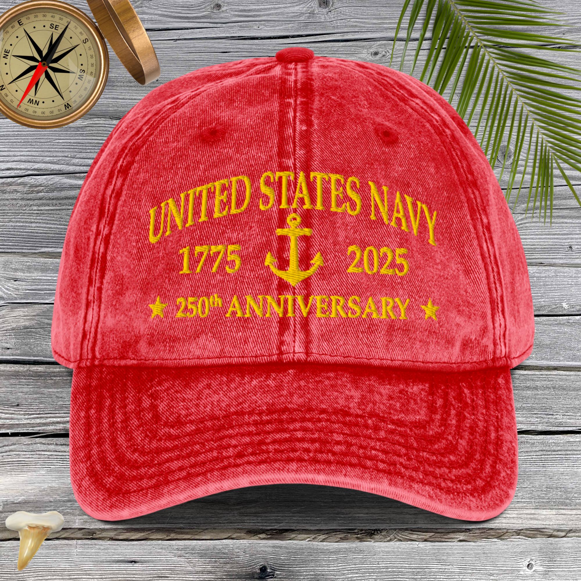 Red cap with 'United States Navy 1775-2025 250th Anniversary' text on a wooden background