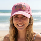 Cute girl in pink cap with American flag design and text on Daytona Beach