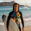 Surfer Dude wearing a black long-sleeve shirt with a colorful floral pattern on a Waikiki Beach