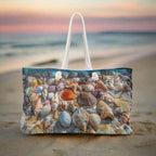 Weekender Beach Bag Seashell Print sitting on a beach