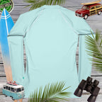 Light blue sun shirt with vintage car, surfboard, and binoculars on a wooden background