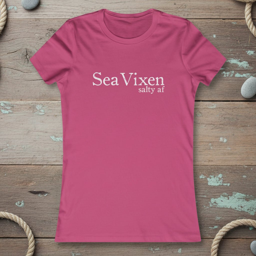 Pink t-shirt with 'Sea Vixen salty af' text on a rustic nautical wood background