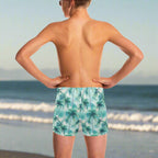 Young dude wearing palm tree patterned swim trunks on a in La Jolla