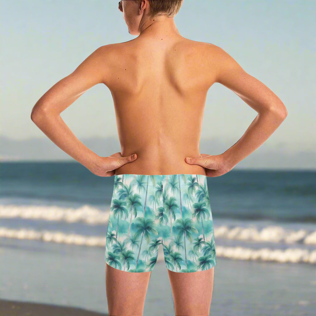 Young dude wearing palm tree patterned swim trunks on a in La Jolla
