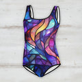 Colorful swimsuit with a stained glass pattern on a rustic wood background