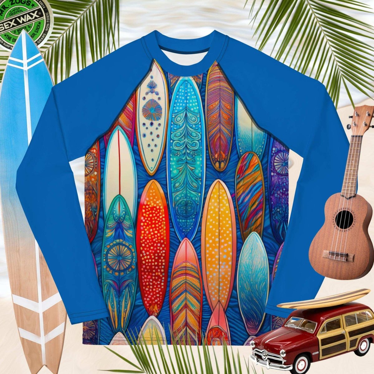 Blue long-sleeve rash guard with colorful surfboard design, surrounded by surfboards, a ukulele, and a vintage toy car.