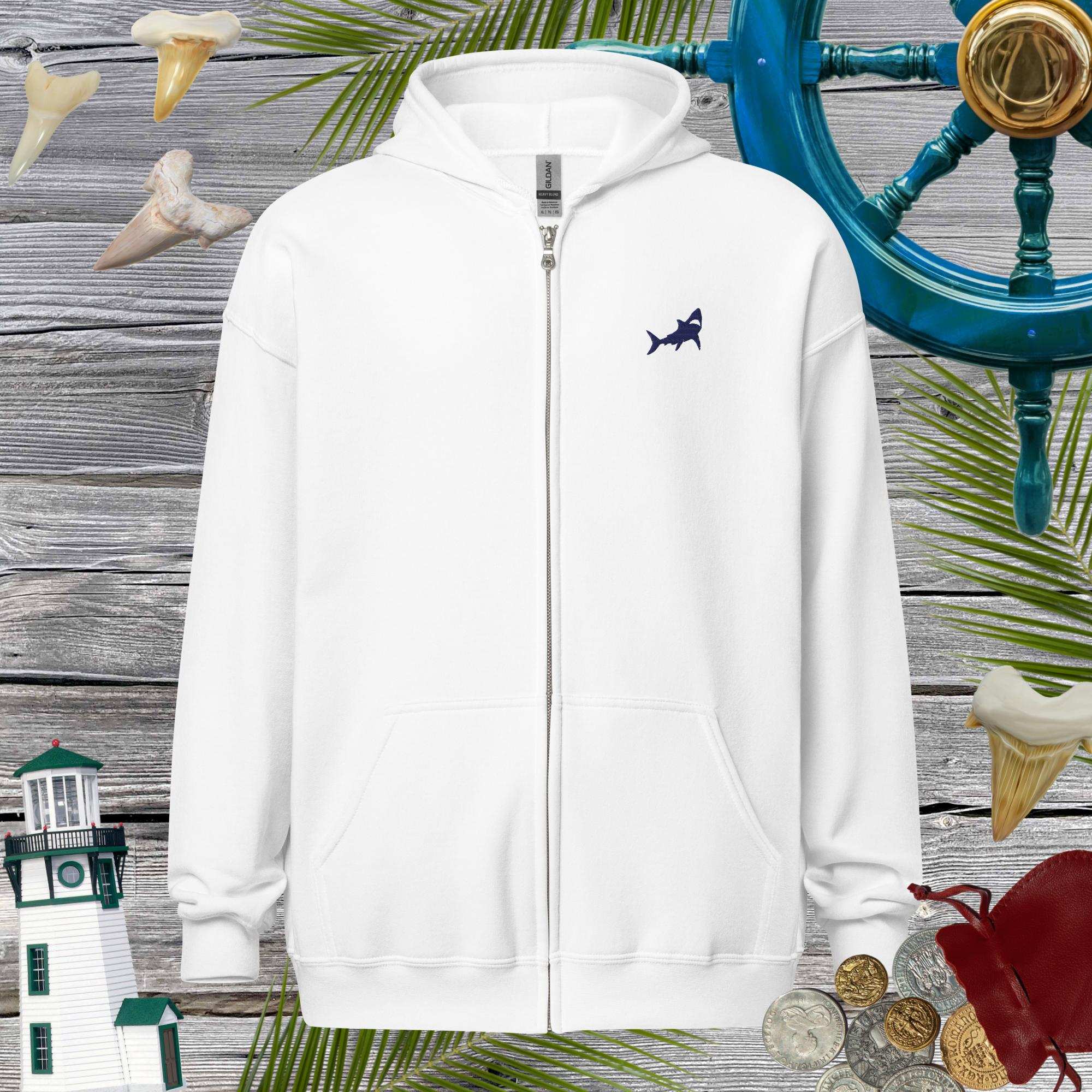 White hoodie with a shark logo on a wooden background with nautical elements.
